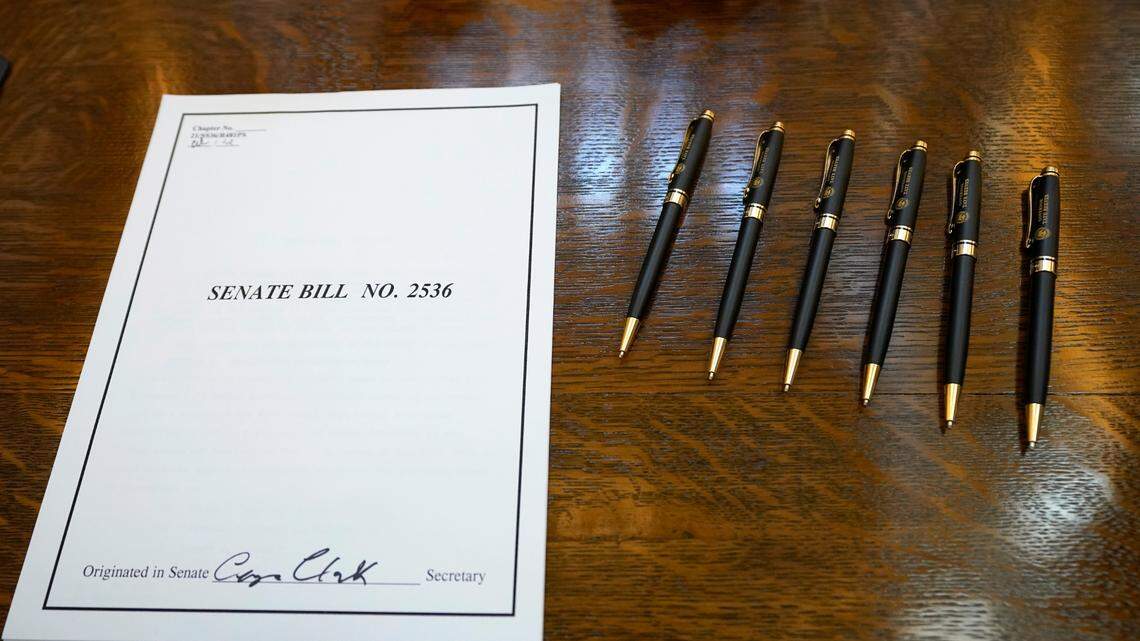 A copy of Mississippi’s Senate Bill 2536, banning transgender athletes from competing on girls or women’s sports teams, awaits Mississippi Gov. Tate Reeves’ signature by use of his official pens, Thursday morning, March 11, 2021, at the Mississippi Capitol in Jackson, Miss. It’s one of many bills introduced in state legislatures this year that would limit transgender student athlete participation in sports. (AP Photo/Rogelio V. Solis)
