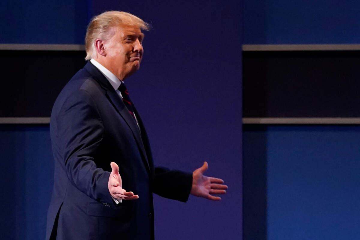 President Donald Trump gestures as he walks on stage for the first presidential debate Tuesday, Sept. 29, 2020, at Case Western University and Cleveland Clinic, in Cleveland, Ohio. (AP Photo/Julio Cortez)