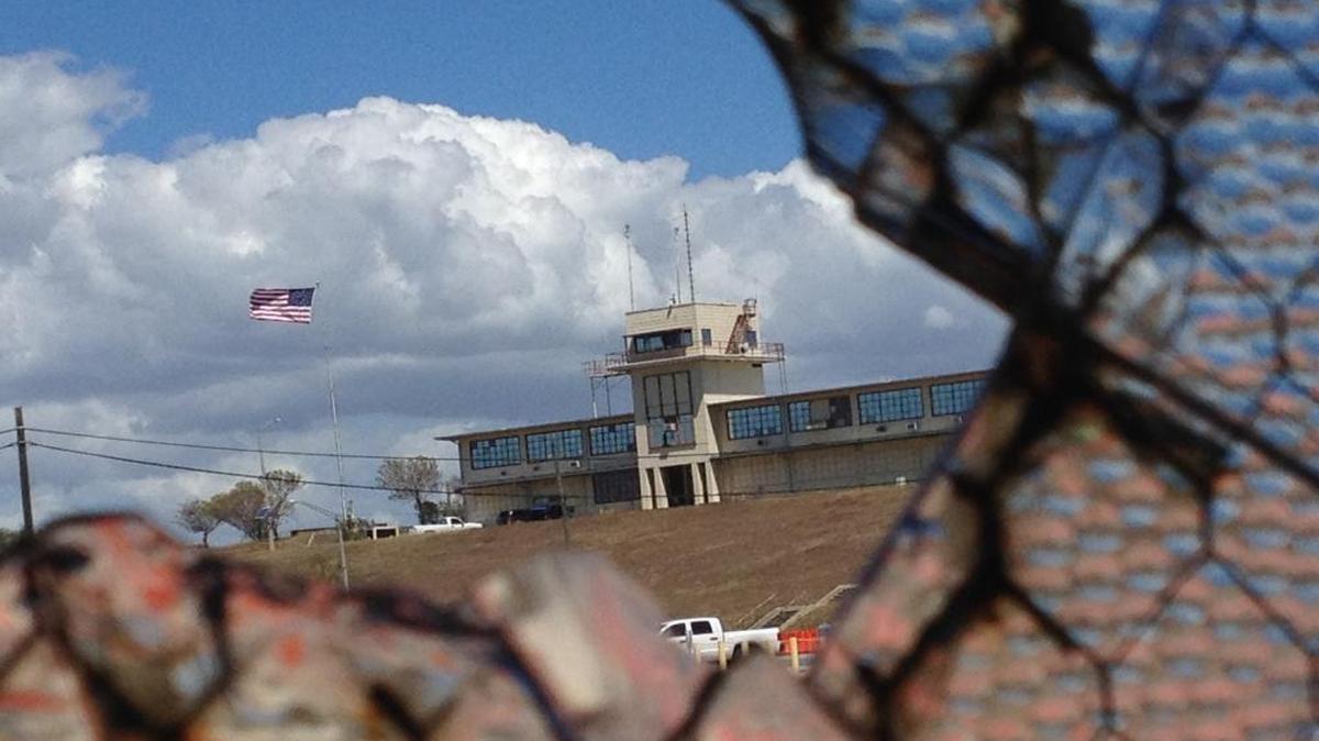 The war court headquarters at Camp Justice, as seen through a broken window at an obsolete air hangar at the U.S. Navy base at Guantánamo Bay, Cuba, on Feb. 28, 2015, in an image approved for release by the U.S. military.