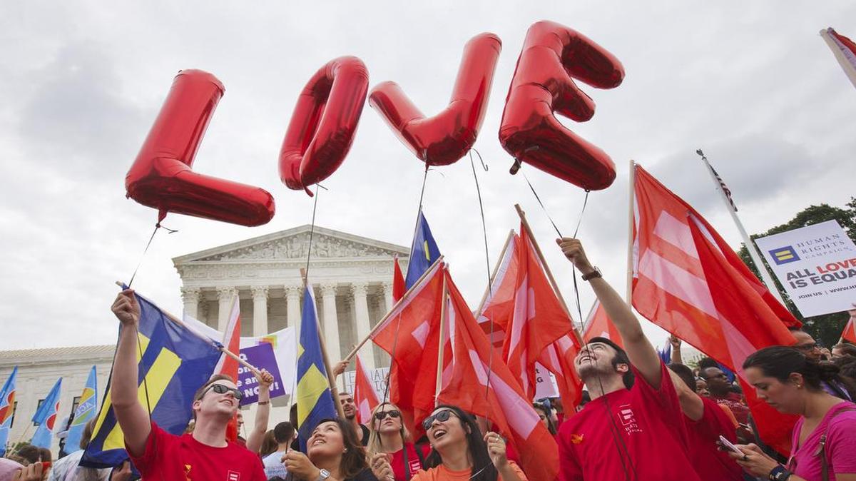 
Same-sex marriage supporters hold up balloons that spell the word "love" as they wait outside of the Supreme Court in Washington, Friday June 26, 2015, before the court declared that same-sex couples have a right to marry anywhere in the US.
