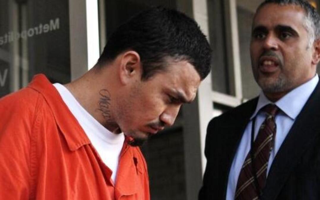 In this April 22, 2009, photo, Ingmar Guandique is escorted from the Violent Crimes Unit in Washington. His conviction in the death of Chandra Levy was vacated, and his retrial is scheduled to begin March 1.