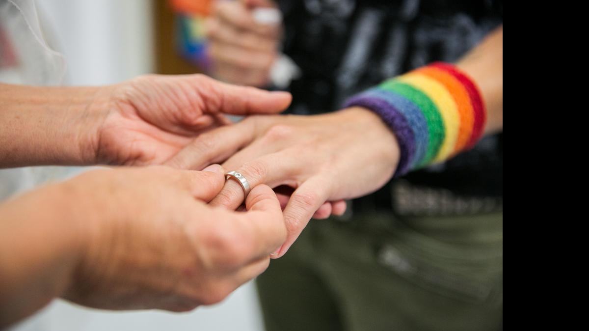 
Natalie Novoa has her wedding ring put on by Eddie Daniels, left, as the couple marry during a ceremony at the L.A. County Registrar office in Beverly Hills, Calif., on Friday, June 26, 2015. The couple have been together for the past 11 years and have been waiting to wed this auspicious day in which the U.S. Supreme Court ruled that same-sex couples have a constitutional right to marriage.
