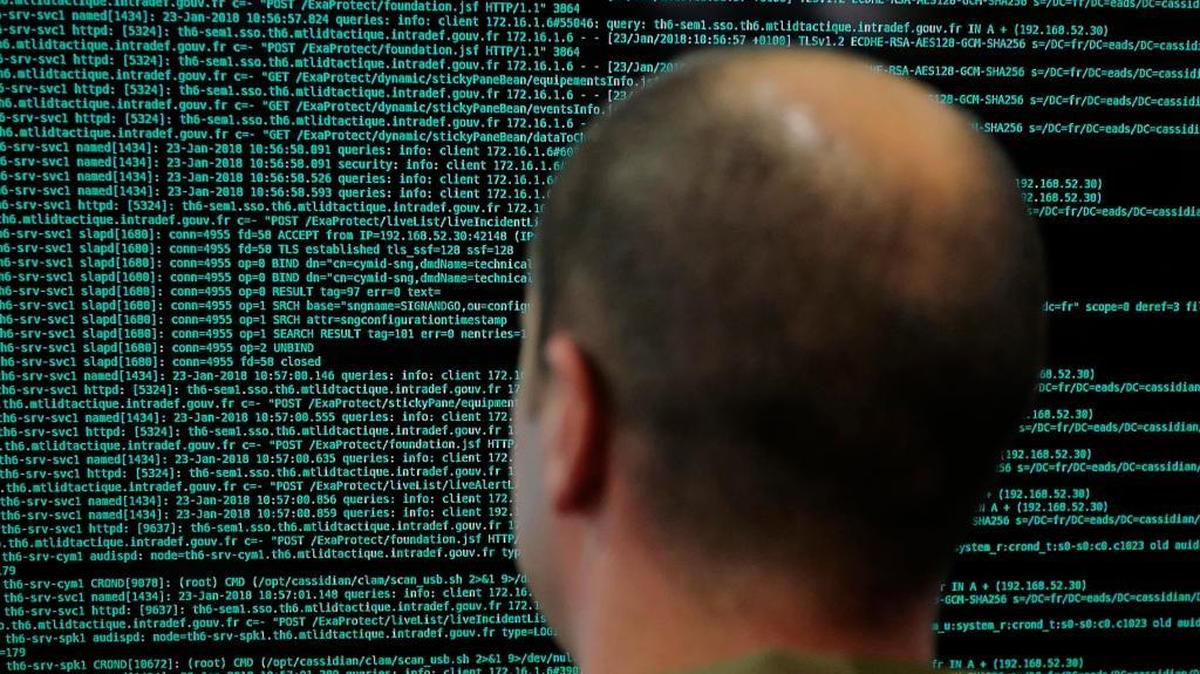 A soldier watches code lines on his computer at the French Defense ministry stand during the International Cybersecurity forum in Lille, northern France, Tuesday Jan. 23, 2018.
