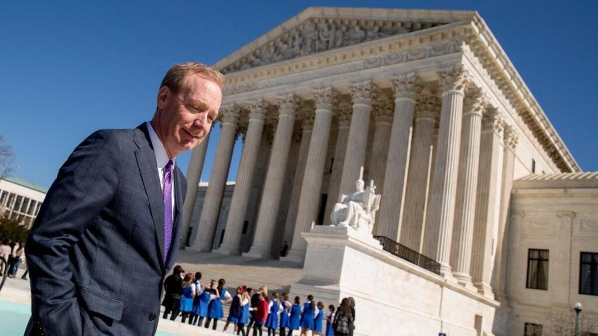 Microsoft President Brad Smith leaves the Supreme Court Tuesday after observing oral arguments before the high court in a dispute over emails that were sought as part of a drug trafficking investigation. Microsoft stores the emails at a data center in Ireland.