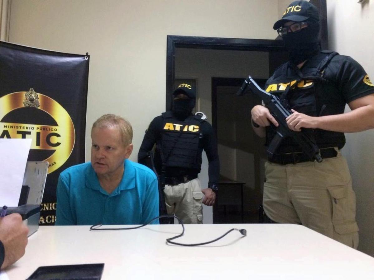 This photo provided by the Honduras public magistrate's office shows Eric Conn with Technical Agency of Criminal Investigation (ATIC) agents after he was captured by police on Monday in the city of La Ceiba, Atlantida, Honduras. Conn, a fugitive Kentucky lawyer who escaped before facing sentencing for his central role in a massive Social Security fraud case, is expected to be transferred to the U.S. on Tuesday.