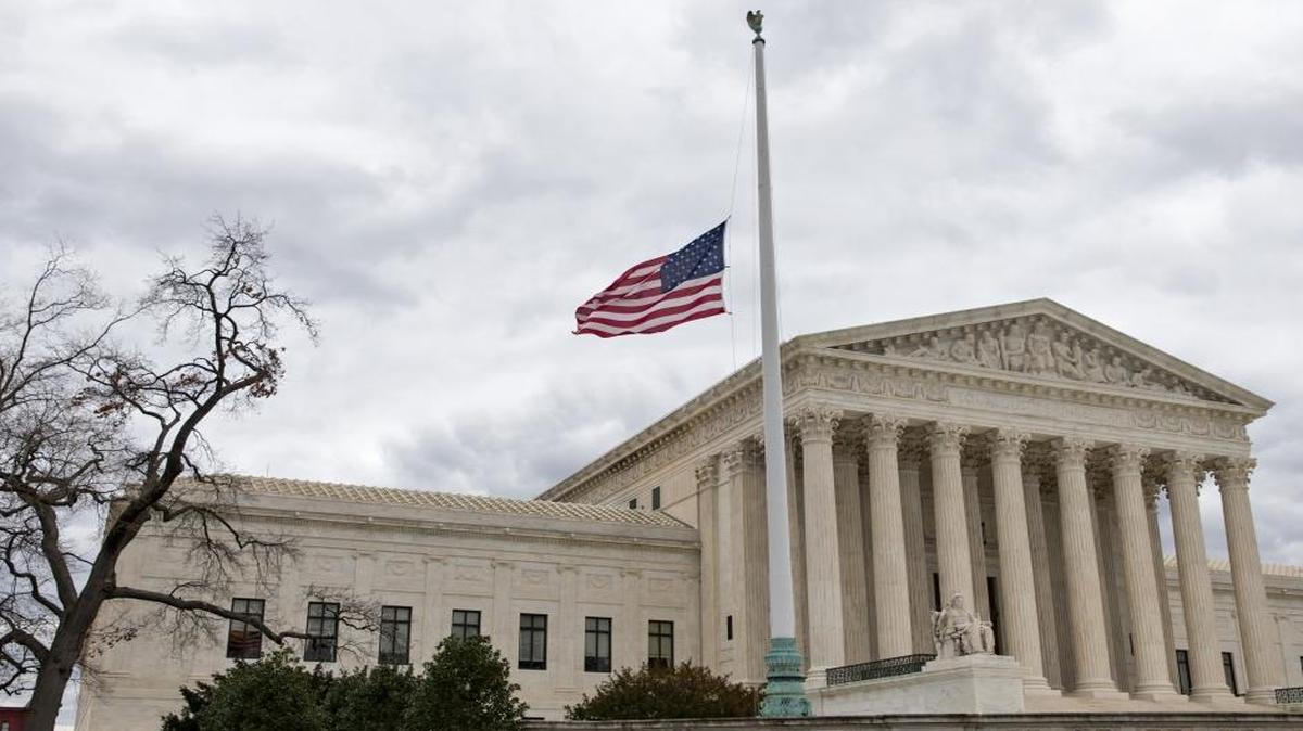 In this Feb. 25, 2016, file photo, a flag in the Supreme Court building's front plaza flies at half-staff in Washington in honor of the late Justice Antonin Scalia.