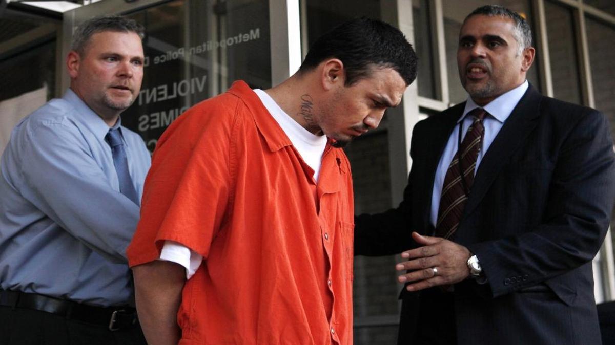 In this April 22, 2009, photo, Ingmar Guandique is escorted from the Violent Crimes Unit in Washington. A judge has set a new trial date for a man convicted of killing Washington intern Chandra Levy.
