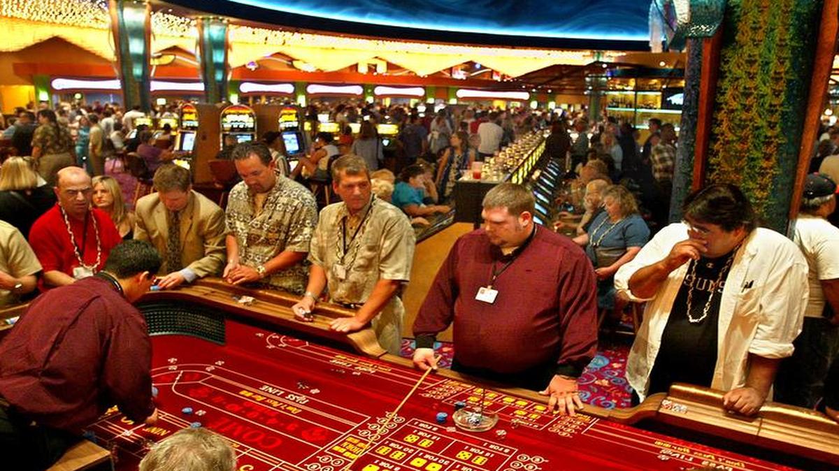 
Patrons crowd around the craps tables and play video slot machines on opening night of the new $78 million, 227,000-square-foot Tulalip Casino, June 6, 2003, located just north of downtown Marysville, Wash.
