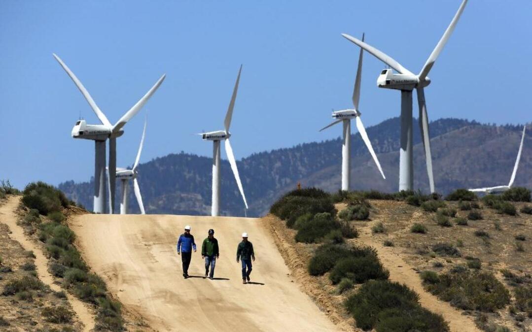 Gregory Wetstone, from left, Randy Hoyle and Kevin Martin of Terra-Gen Power walk past the Alta East wind energy project in the Tehachapi Mountains.