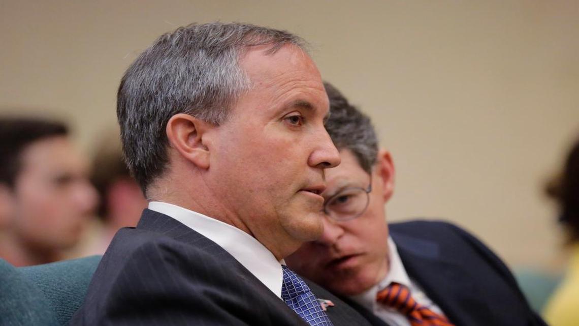 Texas attorney general Ken Paxton, left, with his chief of staff Bernie McNamee, right, waits to testify during a Texas Senate Health and Human Services Committee hearing on July 29, 2015, in Austin.