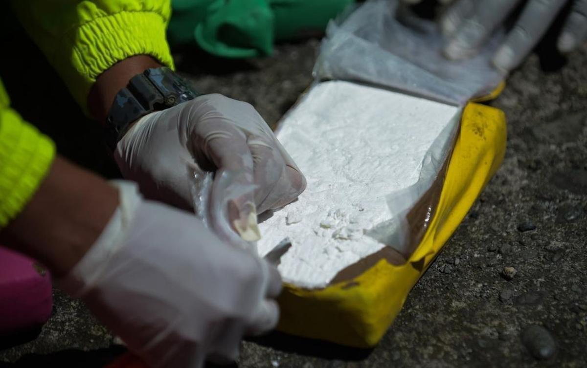 Members of the Colombian anti-narcotics police force test cocaine, part of a one-ton shipment seized in Buenaventura, the nation’s main Pacific port. The coke was in a container destined for Europe.