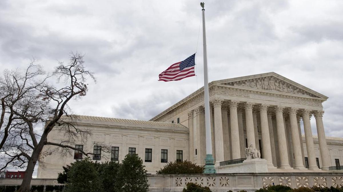 In this Feb. 25, 2016, photo, a flag in the Supreme Court building's front plaza flies at half-staff in Washington, in honor of the late Justice Antonin Scalia.
