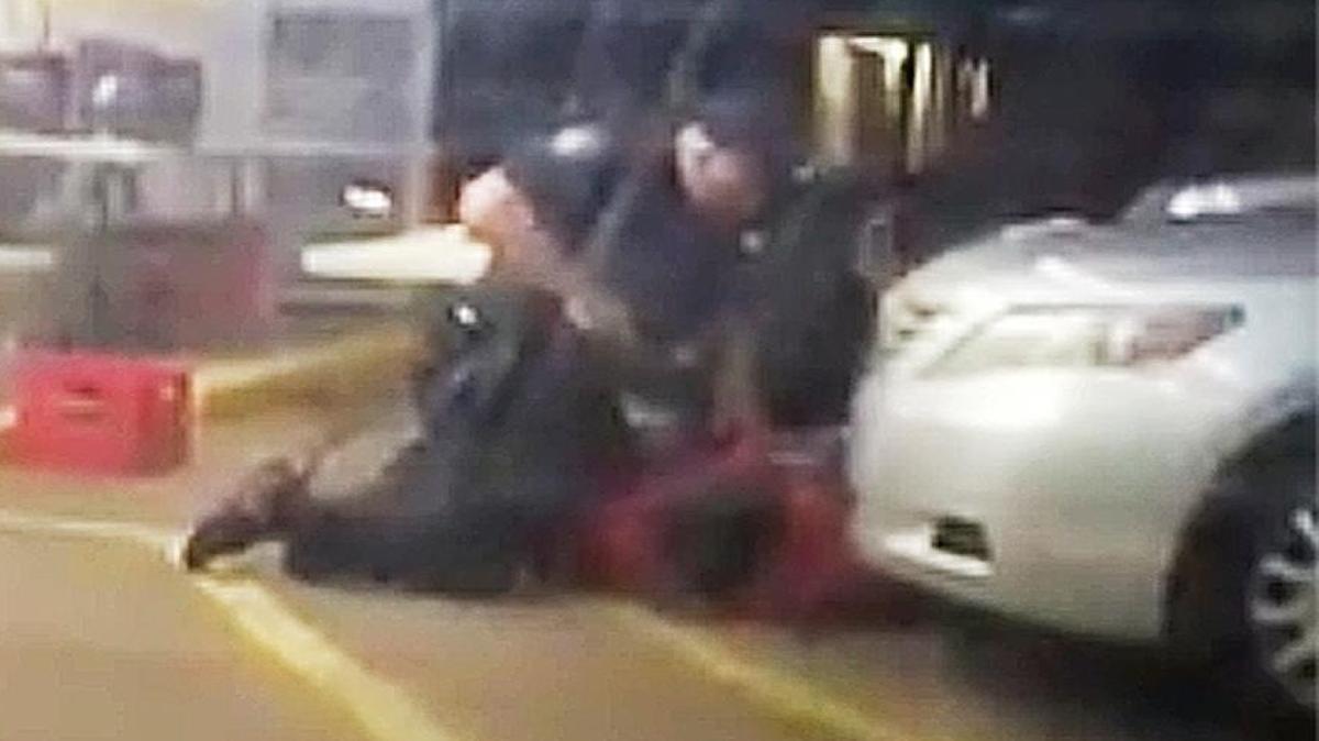 In this Tuesday, July 5, 2016 photo made from video, Alton Sterling is held by two Baton Rouge police officers, with one holding a hand gun, outside a convenience store in Baton Rouge, La. Moments later, one of the officers shot and killed Sterling, a black man who had been selling CDs outside the store, while he was on the ground.