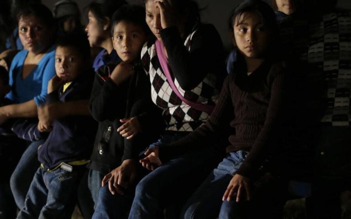 In this June 25, 2014 photo, a group of immigrants from Honduras and El Salvador who crossed the U.S.-Mexico border illegally are stopped in Granjeno, Texas. Just since October, the Border Patrol's Rio Grande Valley sector has made more than 194,000 arrests, nearly triple that of any other sector. Most are from Central America, and many are children. (AP Photo/Eric Gay)