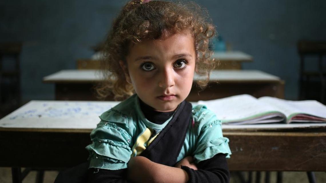 A Syrian refugee girl sits in a classroom at a public school in Lebanon, which has been inundated with people from the war-torn nation.
