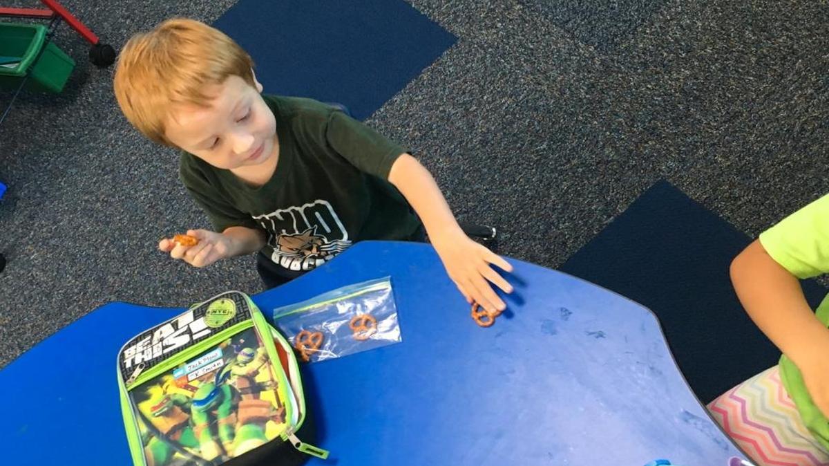 Jack Plow, age 4, shares his pretzels with a classmate in Laura Smith’s transitional kindergarten classroom at Lakewood Elementary School in Sunnyvale, Calif.