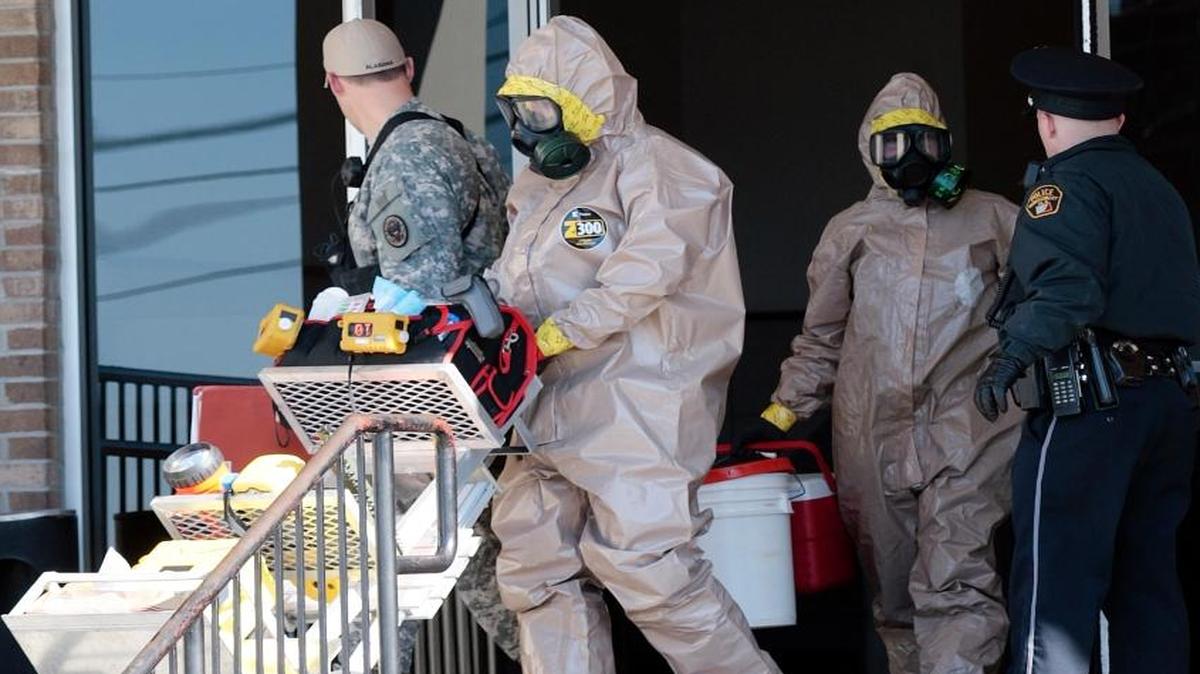 Members of the Alabama National Guard hazardous materials team exit the Montgomery Municipal Court building in Montgomery, Ala., Jan. 5, 2010. The hazardous materials team was called to the building after an envelope mailed to the facility was found containing a powdered substance. A new report from a public health advocacy group says the nation’s readiness to handle health emergencies is slow, short-term and short on funds.