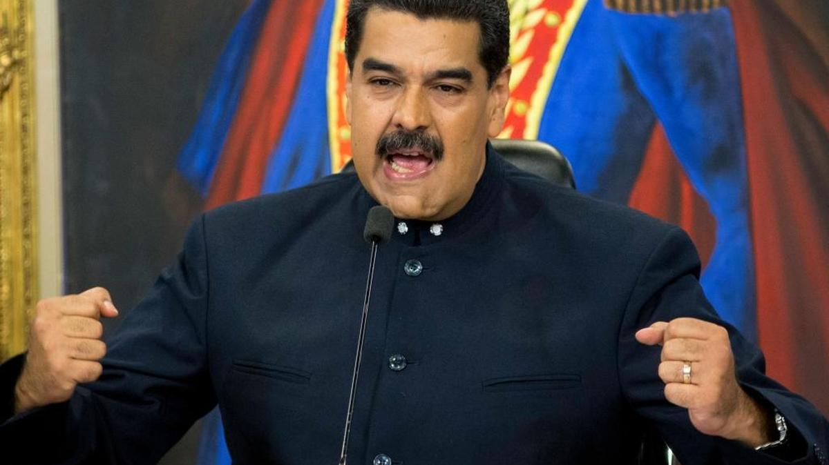 Venezuela's President Nicolas Maduro gives a press conference at Miraflores presidential palace in Caracas, Venezuela. As the ruling party captured a majority of mayoral seats across Venezuela in early December, Maduro said that opposition parties would be banned from future elections as punishment for boycotting the Sunday races.