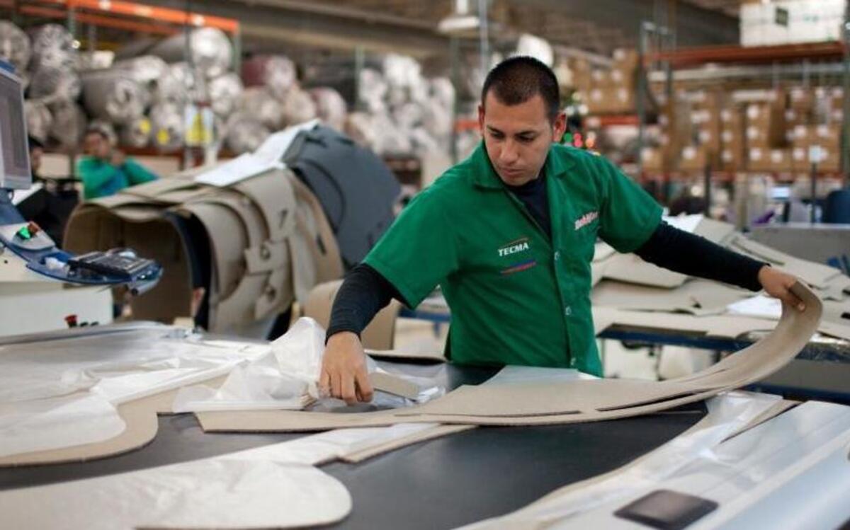 Marcos Godoy of Mexico City manufactures car dash mats at a maquiladora belonging to the TECMA group in Ciudad Juarez, Mexico, on Dec. 27, 2013. Donald Trump and Hillary Clinton both want to make changes to trade agreements to bring jobs back to the United States, but experts say those changes could put additional pressure on North Carolina industries that have already suffered from recent international commerce pacts.