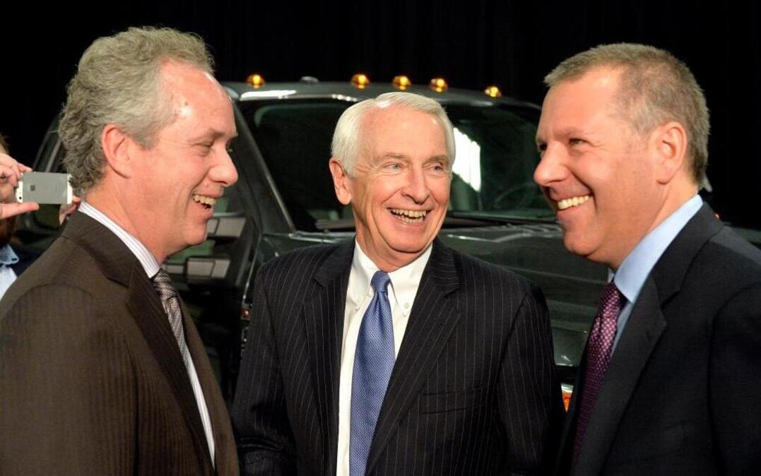 Louisville, Ky., Mayor Greg Fischer, left, Kentucky Gov. Steve Beshear, center, and Ford President of the Americas Joe Hinrichs share a laugh following the announcement that the Ford Motor Co. will be adding 2,000 jobs and investing $1.3 billion at the Kentucky Truck Plant in Louisville to build the new aluminum-body Super Duty truck, Dec. 1, 2015.