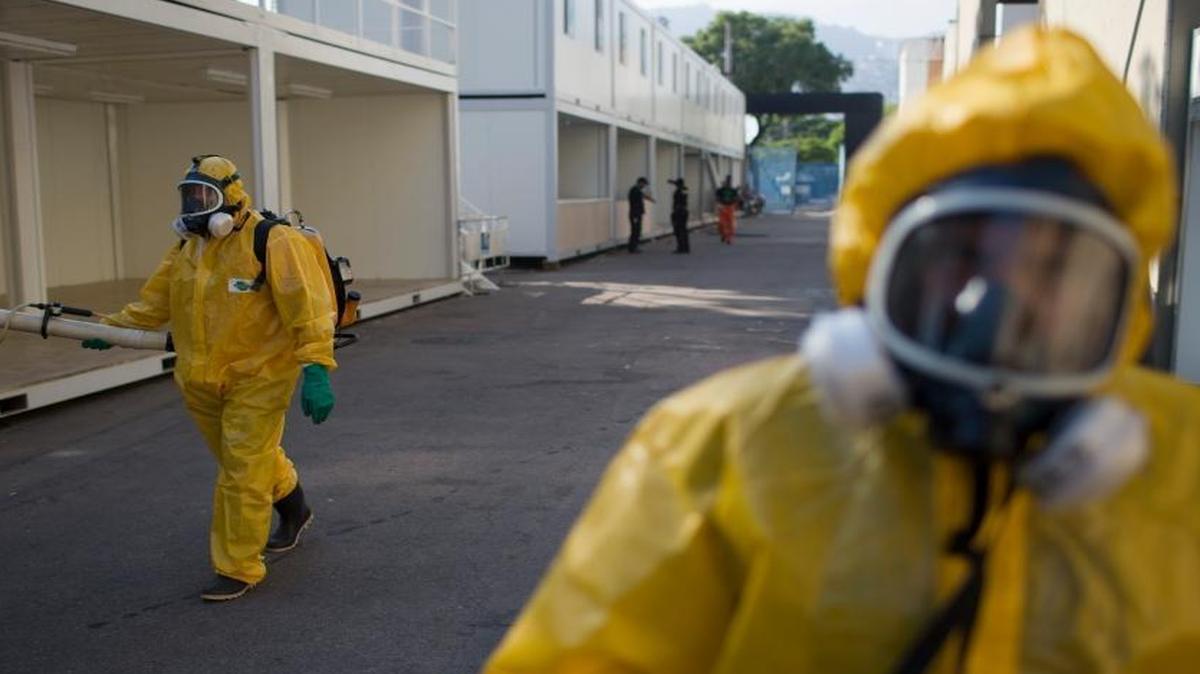 A health worker sprays insecticide to combat the Aedes aegypti mosquitoes that transmits the Zika virus at the Sambadrome in Rio de Janeiro, Brazil, Tuesday. U.S. health officials urged doctors in the United States to test newborns showing signs of the Zika virus.