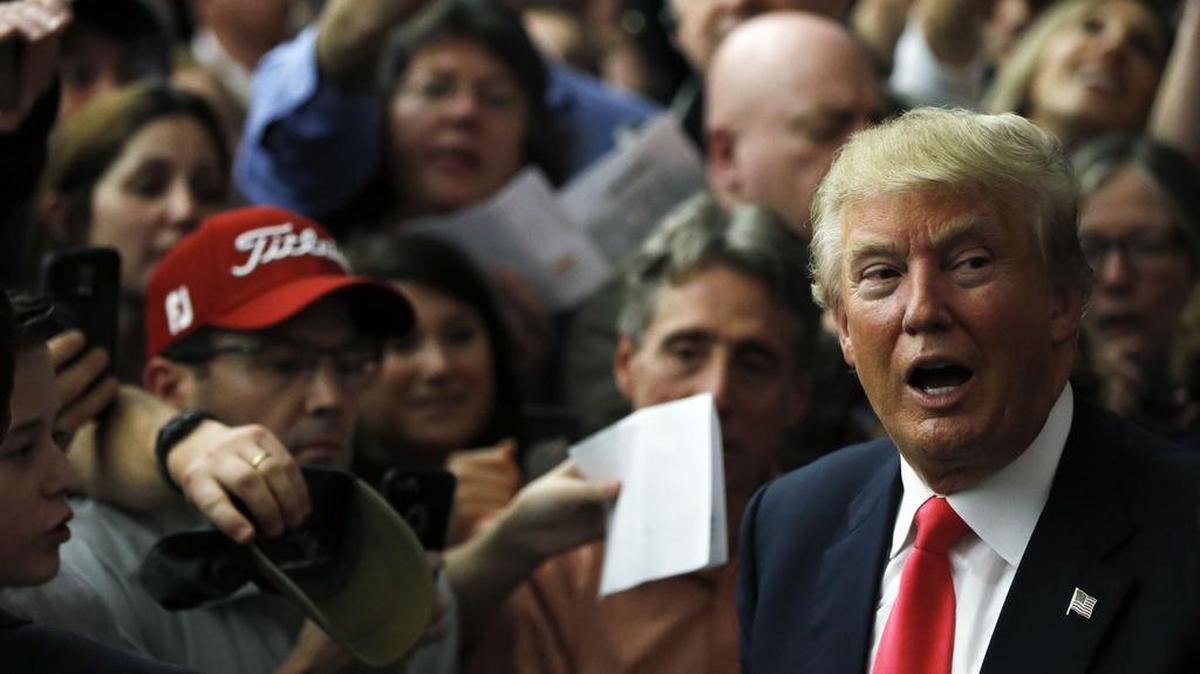 Republican presidential candidate Donald Trump meets with attendees during a campaign stop Tuesday, Feb. 2, 2016, in Milford, N.H.