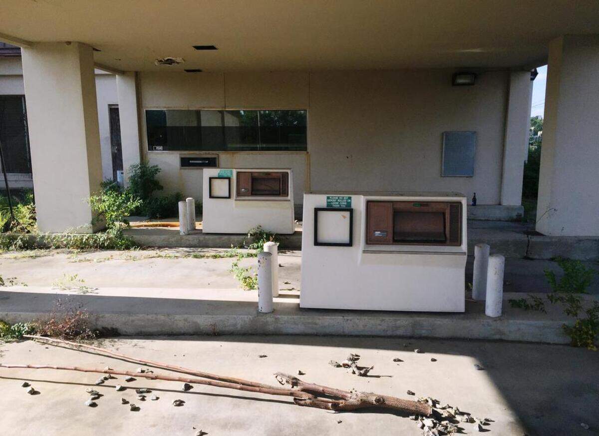 A bank property on Pio Nono Avenue in Macon, Ga., is abandoned and dotted by weeds. In poorer areas of Middle Georgia, banks are outnumbered by non-traditional lenders such as title-pawn companies, whose terms are considered predatory by consumer advocacy groups.