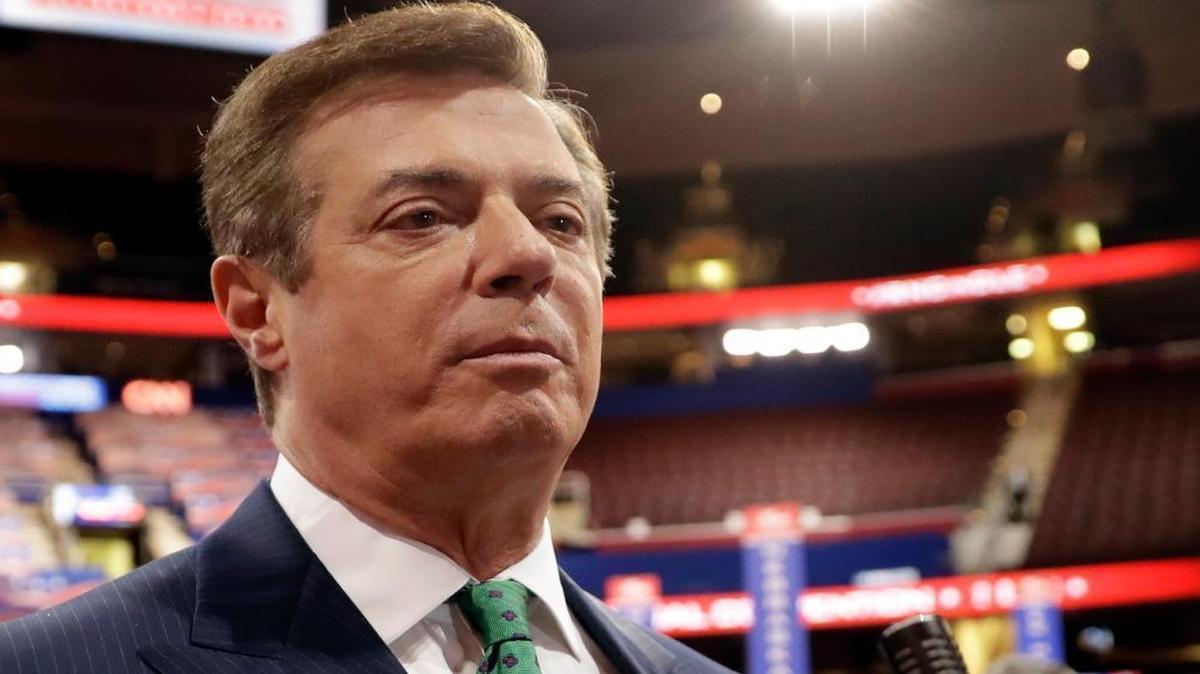 In this July 17, 2016 photo, then-Donald Trump campaign chairman Paul Manafort spoke with reporters on the floor of the Republican National Convention in Cleveland. Manafort is suggesting he will register with the Justice Department as a foreign agent for lobbying work he did on behalf of Ukraine.