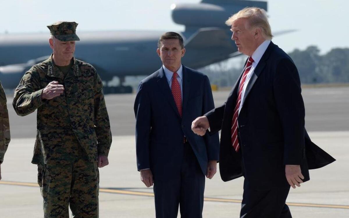 President Donald Trump passes Joint Chiefs Chairman Gen. Joseph Dunford, left, and then-National Security Adviser Michael Flynn as he arrives via Air Force One at MacDill Air Force Base in Tampa, Fla., Feb. 6, 2017. Trump stopped for a visit to the headquarters for U.S. Central Command and U.S. Special Operations Command before returning to Washington.