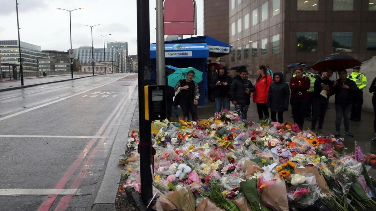 People lay flowers for victims of Saturday's attack on London Bridge, Monday, June 5, 2017. The Department of Homeland Security said the attacks have not prompted any policy changes.