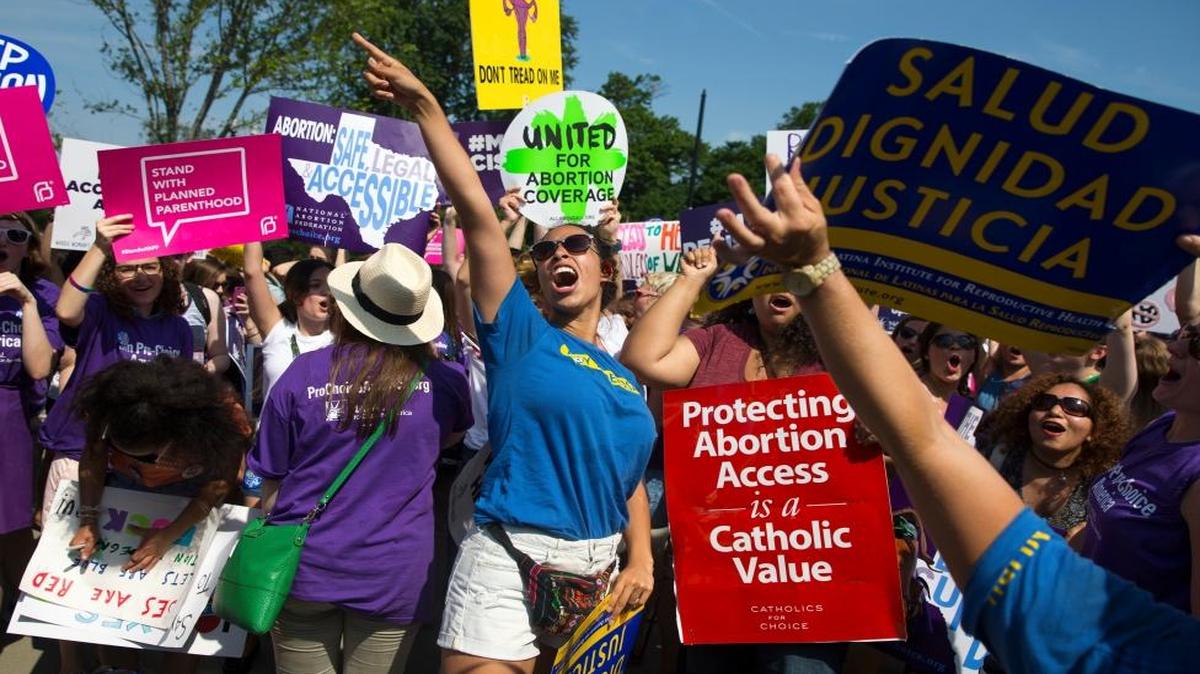 Stephanie Castro, center, celebrates during a rally at the Supreme Court in Washington, Monday, June 27, 2016, after the court struck down Texas' widely replicated regulation of abortion clinics.