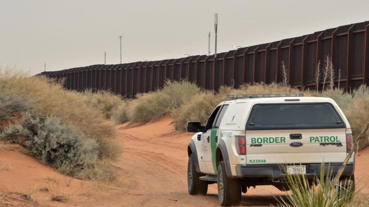 A U.S. Border Patrol agent drives near the U.S.-Mexico border fence in Santa Teresa, N.M. in this Jan. 4, 2016 photo. An increase in families and children arriving at the U.S. southern border from Central America has prompted fears of another crisis like the one that dominated national news during the summer of 2014. (AP Photo/Russell Contreras)