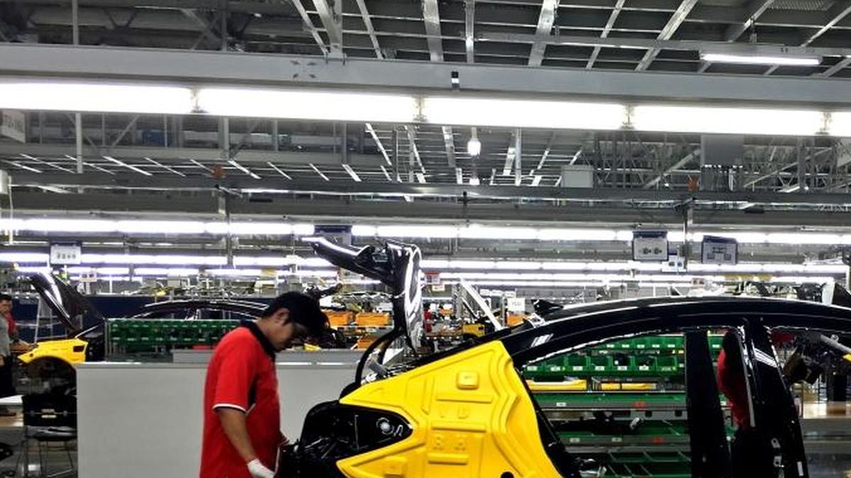Workers assemble the Forte sedan on the floor of a Kia plant in Nuevo Leon, Mexico, which began production in May.