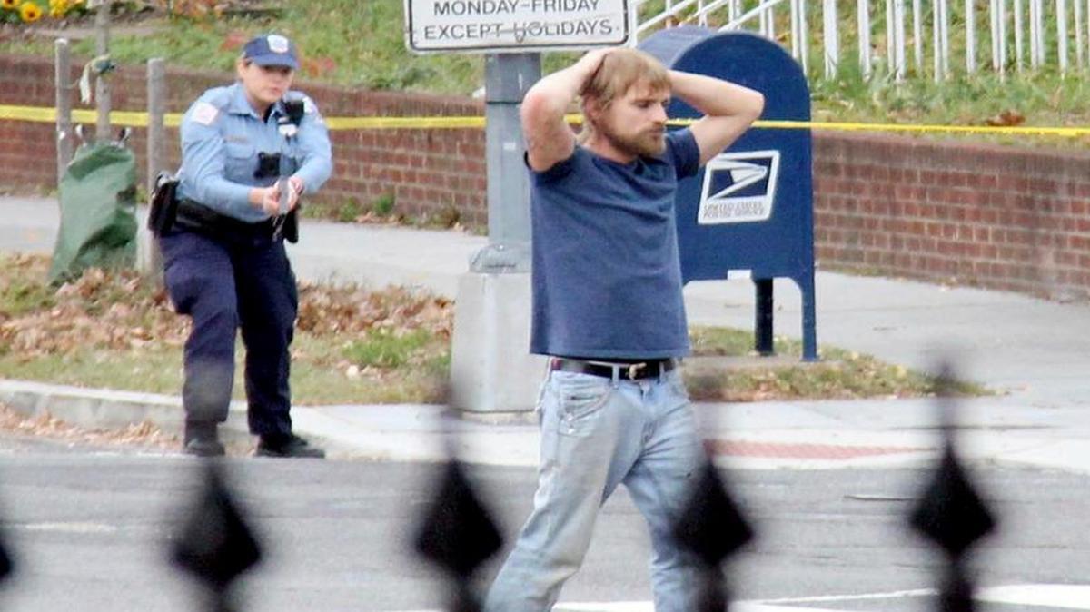 Edgar Maddison Welch, 28 of Salisbury, N.C., surrenders to police on Sunday, in Washington. Welch, who said he was investigating a conspiracy theory about Hillary Clinton running a child sex ring out of a pizza place, fired an assault rifle inside the restaurant on Sunday injuring no one, police and news reports said.