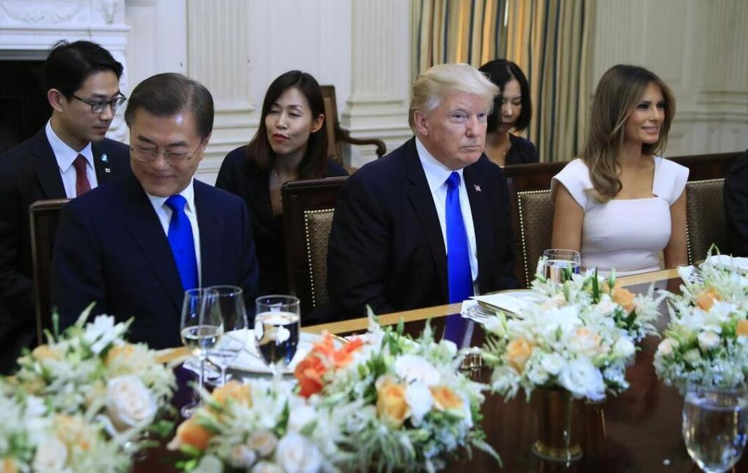 President Donald Trump, first lady Melania Trump, right, and South Korean President Moon Jae-in, left, are seated during a dinner in the State Dining Room of the White House in Washington, Thursday, June 29, 2017.
