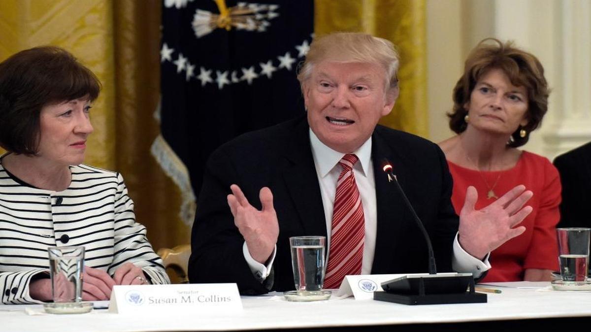 President Donald Trump, center, speaks as he meets with Republican senators on health care in the East Room of the White House in Washington, Tuesday, June 27, 2017. Sen. Susan Collins, R-Maine, left, and Sen. Lisa Murkowski, R-Alaska, right, listen