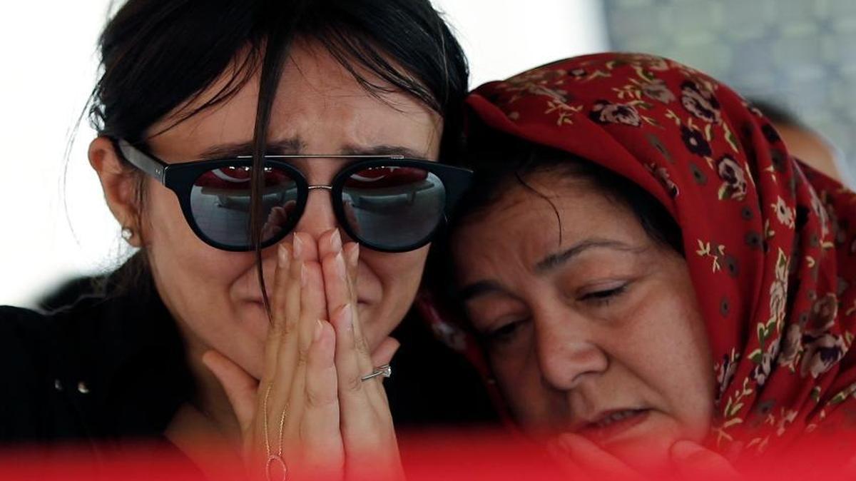 Mourners react next to the coffin during the funeral for Gulsen Bahadir, 28, a Turkish Airlines (THY) flight attendant killed Tuesday at the blasts at Ataturk airport, in Istanbul,Wednesday, June 29, 2016. Suicide attackers killed dozens and wounded more than 140 in the latest in a series of bombings to strike Turkey in recent months. Turkish authorities have banned distribution of images relating to the Ataturk airport attack within Turkey.