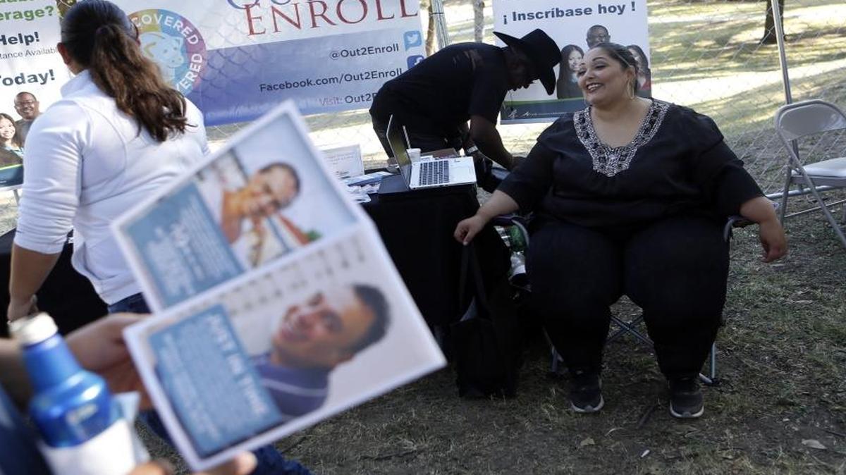Amanda Rodriguez, Site Supervisor for Cognosante in the Dallas-Fort Worth area, runs an Out 2 Enroll booth for enrollment awareness and outreach for the Affordable Care Act at the 2nd Annual Texas Latino Gay Pride Festival at Reverchon Park in Dallas, Texas, on Oct. 10, 2015.