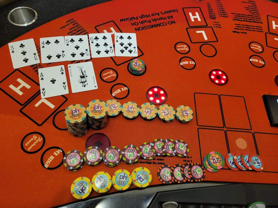 The poker player’s winning cards are shown.