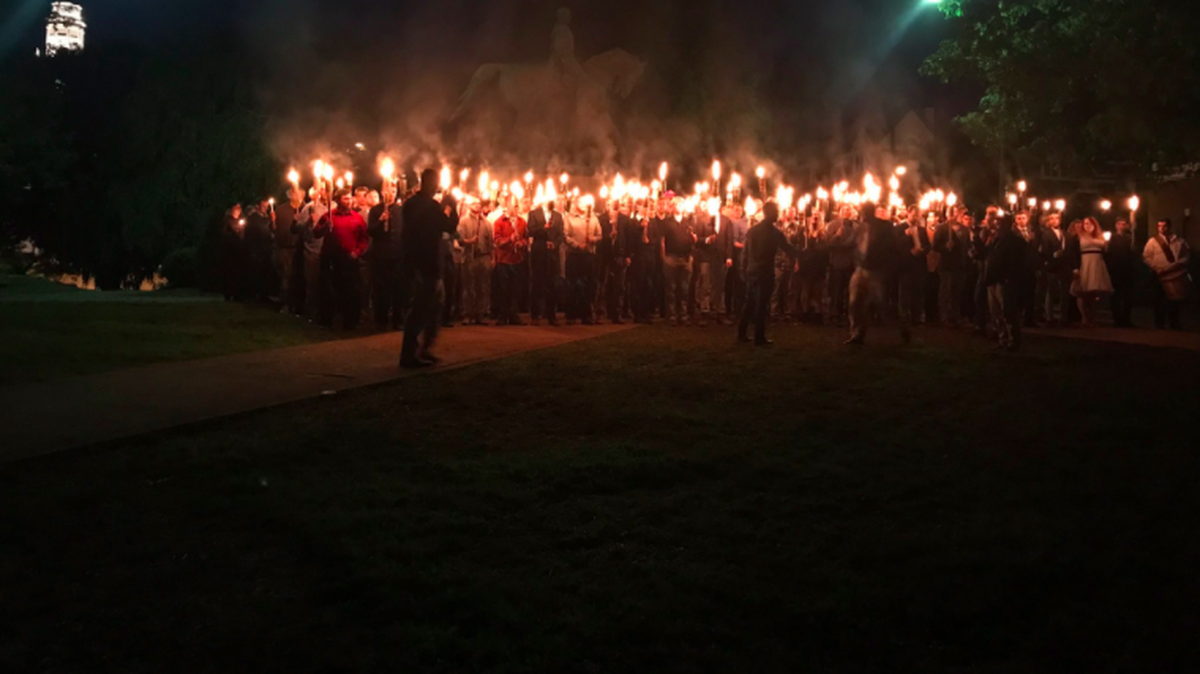 A crowd gathers near a statue of Confederate General Robert E. Lee to protest plans by city government to remove it in Charlottesville, Virginia.