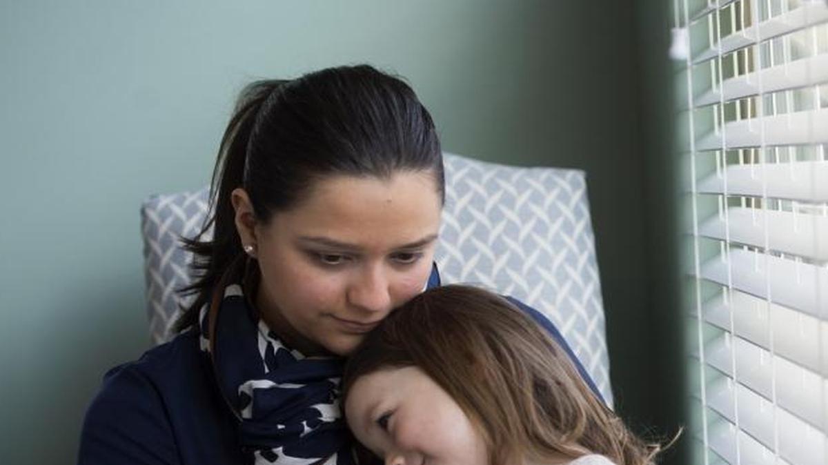 Monica Meeker of Nashville, Tenn., holds her daughter, Camilla, in the dining room next to the same style of blinds Camilla got tangled in last year and nearly died. When the Meekers removed the blinds and installed curtains, their homeowners association notified them that the curtains were a violation of HOA rules, which required blinds in windows facing the street. The Meekers spent $7,000 in attorney fees fighting the association, but it refused to change its policy. The family eventually moved to a home that is not in an HOA. The November death of 3-year-old Elsie Mahe, who died after strangling on a window cord in her family’s Utah home, brought back troubling memories for Meeker, who wants to warn other families about the dangers of cords on blinds.