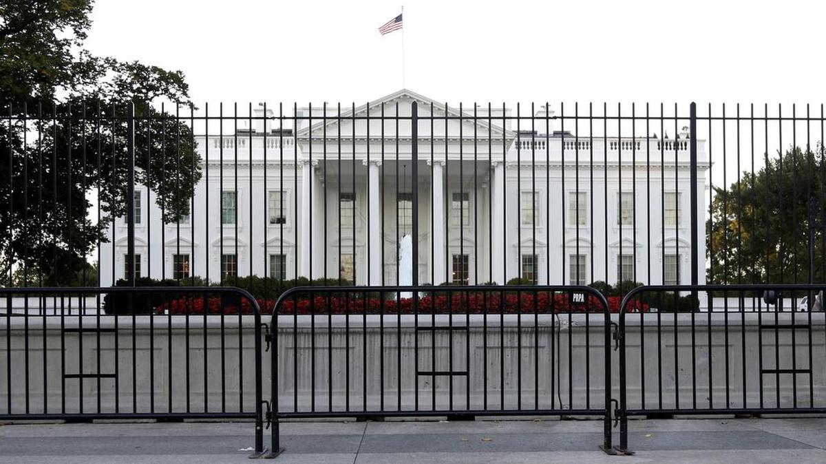 FILE - In this Sept. 22, 2014, file photo. the perimeter fence sits in front of the White House fence on the North Lawn along Pennsylvania Avenue in Washington.