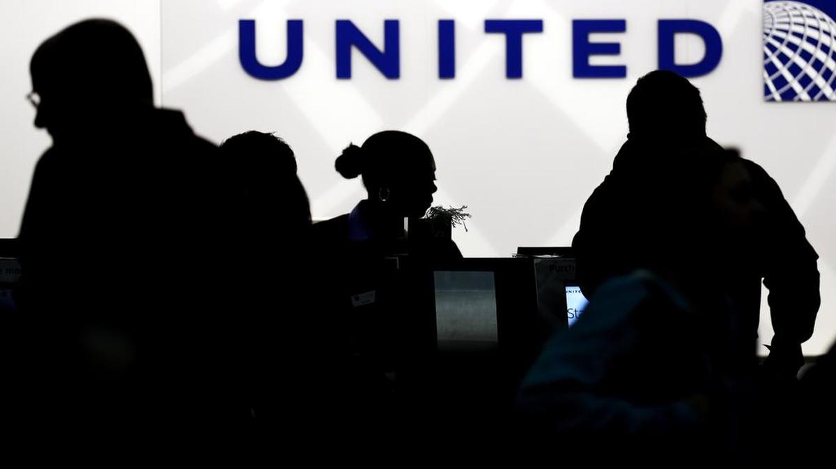 Travelers check in at the United Airlines ticket counter at O’Hare International Airport in Chicago in 2013.