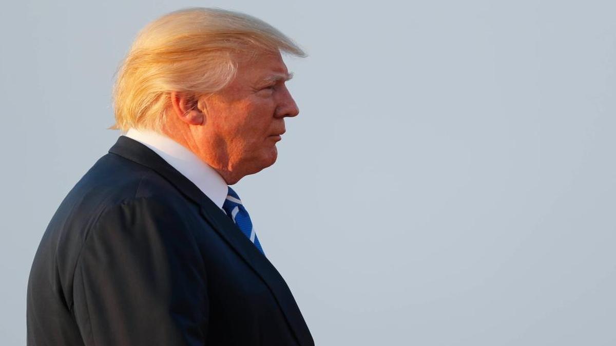 President Donald Trump heads to Air Force One at Morristown Municipal Airport for areturn flight to the Washington area.