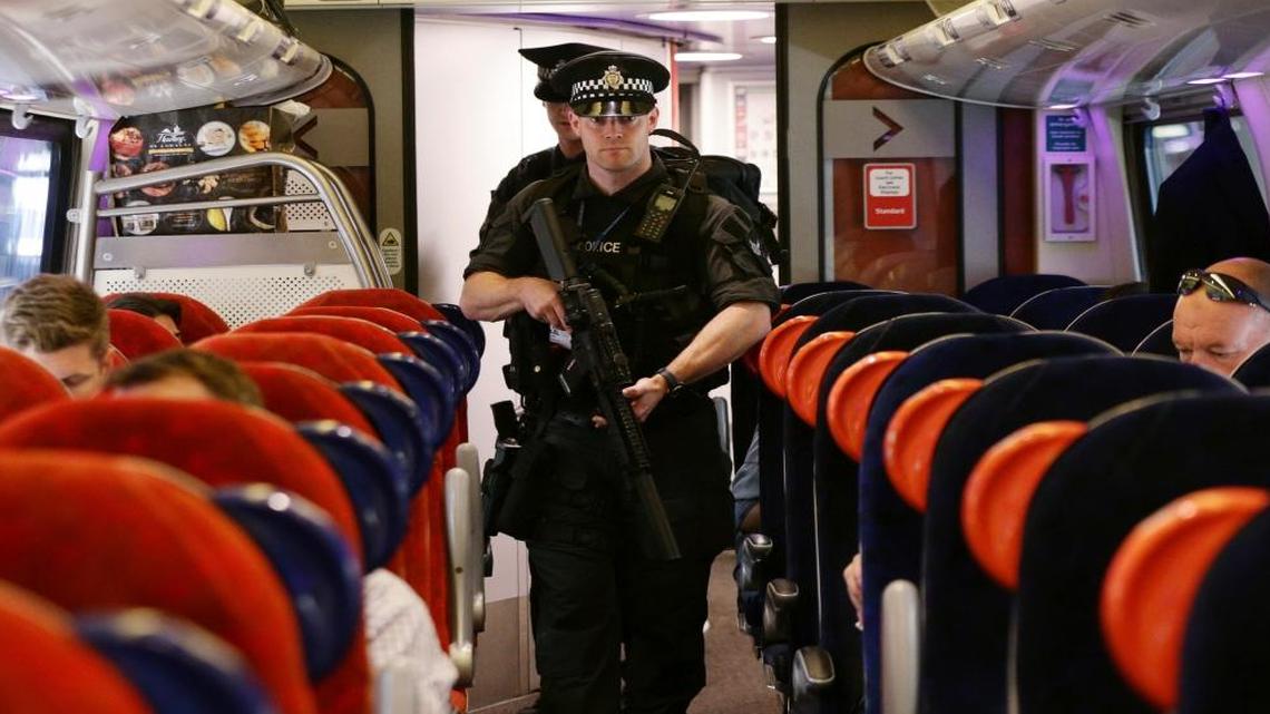 Armed British Transport Police Specialist Operations officers on board a train at Euston station in London as armed police officers are patrolling on board trains nationwide for the first time Thursday May 25, 2017.
