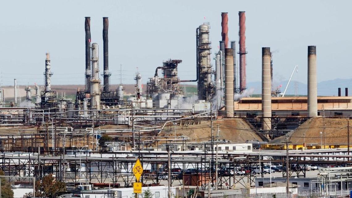 A tanker truck passes the Chevron Refinery in Richmond, Calif. on March 9, 2010. Chevron is one of several oil companies fending off lawsuits from California cities and counties, whose leaders contend the oil giants conspired to mislead the public about climate change. On Wednesday, a U.S. District Court judge in San Francisco presided over a first-of-its-kind court “tutorial,” in which two of the cities and oil company lawyers presented their views on history and science of global warming.
