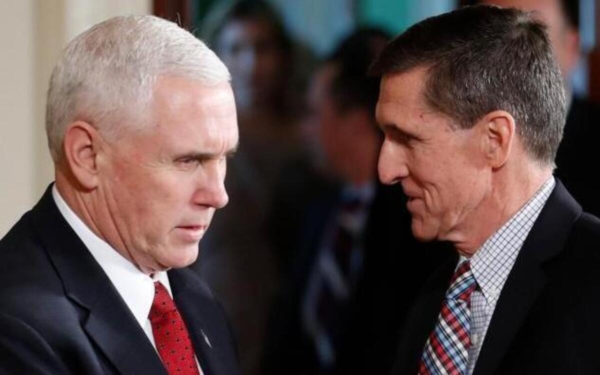 Former National Security Adviser Michael Flynn (right), who was fired in February for misleading Vice President Mike Pence and other officials about his conversations with the Russian ambassador to the U.S. In photo, Pence, left, and Flynn shake hands before the start of the President Donald Trump and Japanese Prime Minister Shinzo Abe joint news conference in the East Room of the White House, in Washington, Feb. 10, 2017.