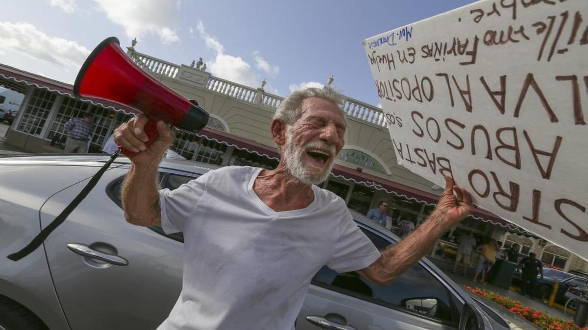 Eloy Angulo, 79, a former Cuban political prisoner, protests outside the Cafe Versailles in Little Havana on July 27, 2016.