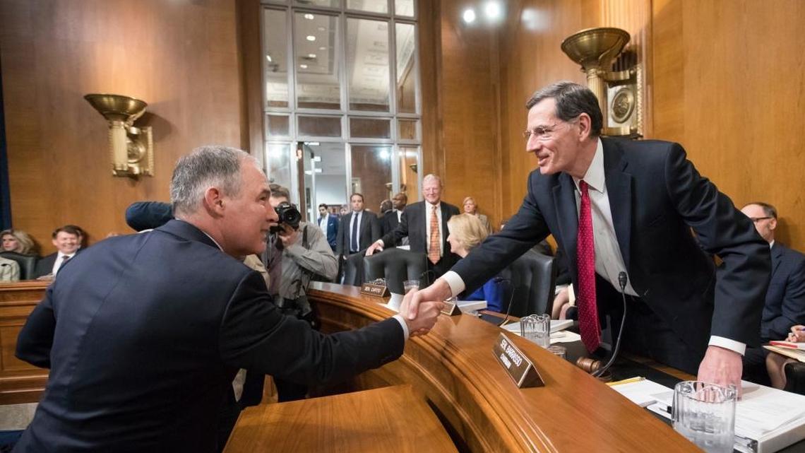 Scott Pruitt, left, nominee to serve as Environmental Protection Agency, is welcomed on Capitol Hill in Washington, Wednesday, Jan. 18, 2017, by Sen. John Barrasso, R-Wyo., the chairman of Senate Environment and Public Works Committee.