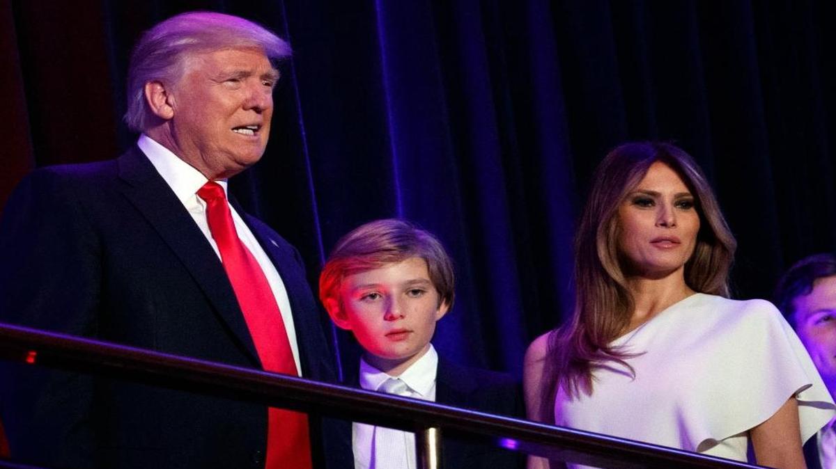 President-elect Donald Trump, left, with his son Barron and wife Melania, in New York. Trump says he will move to the White House but his wife and young son will follow him at the end of the school year.